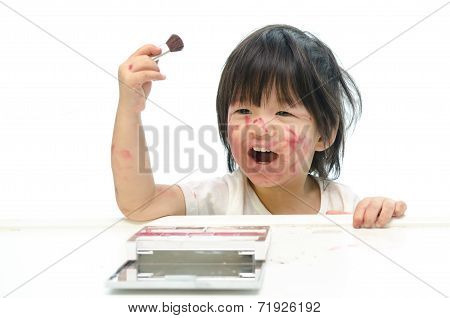 Little asian baby playing with mother's cosmetics