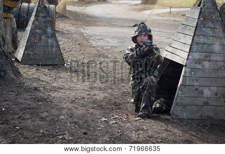 Little boy player with gun during lasertag game.