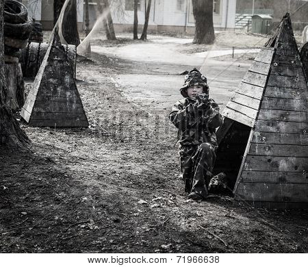Little boy player with gun during lasertag game.