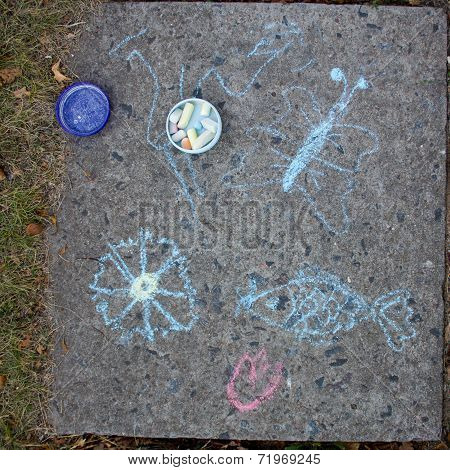 Childrens Draw fish With Chalk On Asphalt.