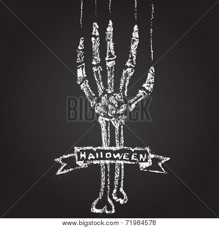 Skeleton hand with chalk on a blackboard, and a banner. Hallowe