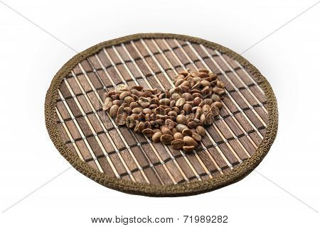 Heart Of Coffee Beans On A Round Matting Isolated