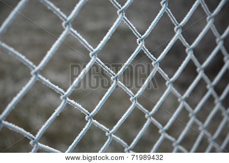 Frozen wire fence in winter frost