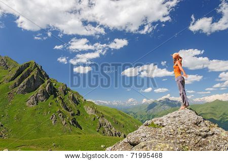 Young woman standing on a rock