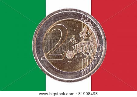 Common Face Of Two Euro Coin On Flag Of Italy
