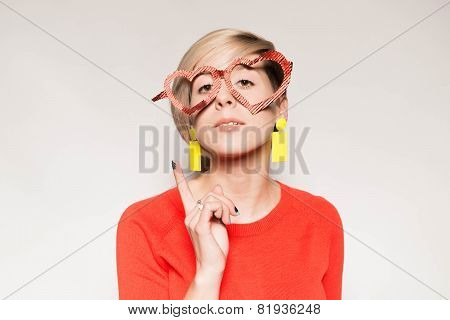 Valentine's Day. Girl with glasses in the shape of heart