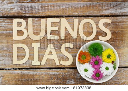 Buenos Dias (Good morning in Spanish) written with wooden letters, and santini flowers