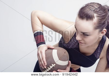 Sport Concepts: Professioanl Female Soccer Player With Ball For American Football.