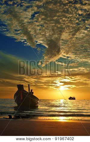 Small thai boat at tropical sunset
