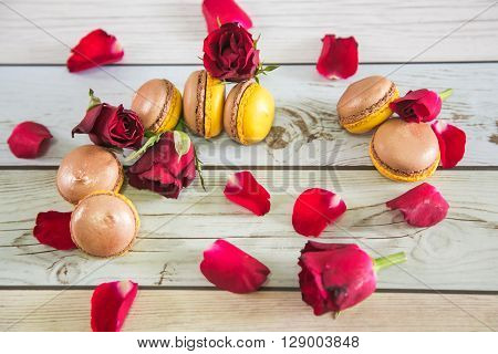 Natural french macaruns and red roses pentals on flat
