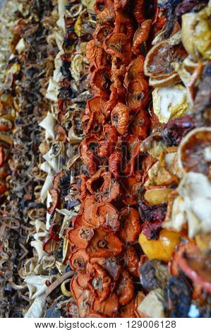Wall of fruits to dry hung with ropes with oranges lemons tomatoes..