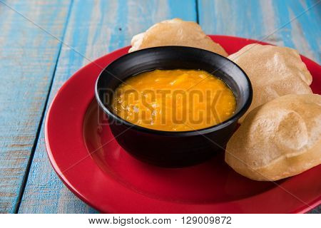 Aamras or Aam Ras Puri: Puri which is an indian fried small bread and alphonso mango pulp is a popular lunch especially during Padwa, the Marathi new year, maharashtrian lunch/dinner menu