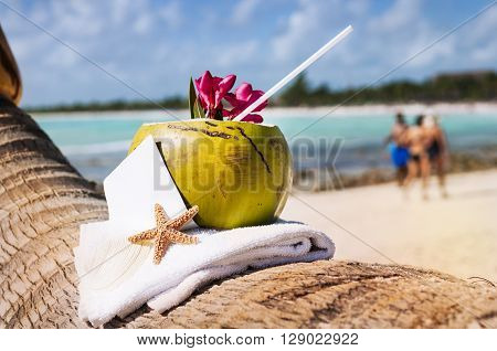 Coconut cocktail starfish tropical Caribbean beach refreshment and towel