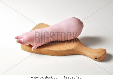 Stuffed pig foot Zampone on cutting board