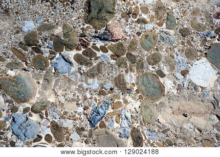 Pebbles bound together in natural cement resembling concrete