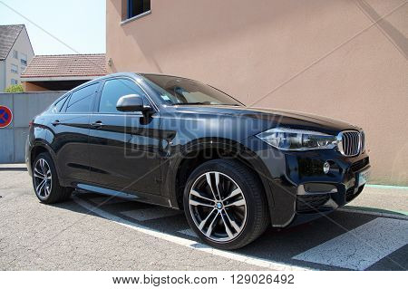 Saverne, Bas-Rhin, France - May 7, 2016: Black BMW X6 parked on the side of the street in the city of Saverne.