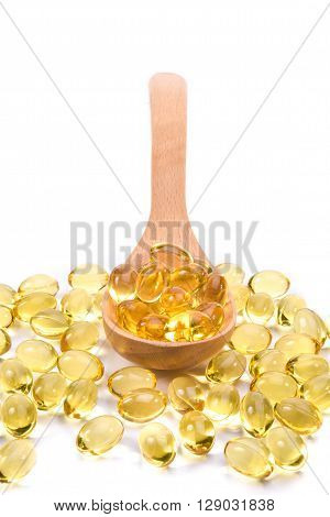 Fish Oil Capsules In A Wood Spoon On White Background