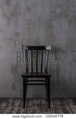 Old wooden chair in the empty room