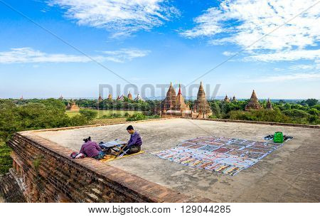 Bagan Myanmar - January 12 2012: Young people on a platform over the plain with thousand of 880-year old temple ruins.