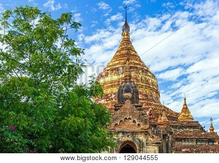 Myanmar, Bagan, the golden pagoda in the plain with thousand of 880-year old temple ruins.