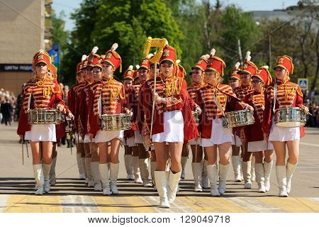 Orel Russia - May 9 2016: Celebration of 71th anniversary of the Victory Day (WWII). Girls in red hussar uniform and short skirts marching horizontal