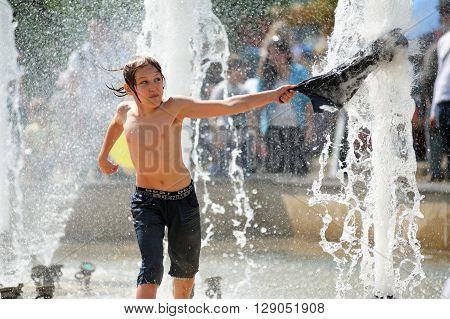 Orel Russia - May 9 2016: Celebration of 71th anniversary of the Victory Day (WWII). Boy playing in fountain closeup