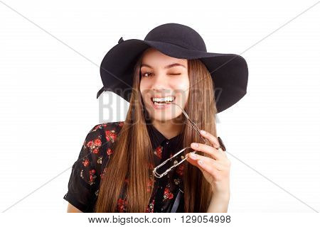 girl in hat posing in the studio, fashion concept