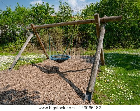 Lone swing seat in a summer field in Germany