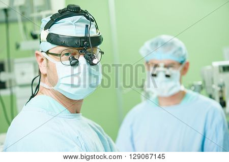 male cardiac surgeon at child cardiosurgery operating room