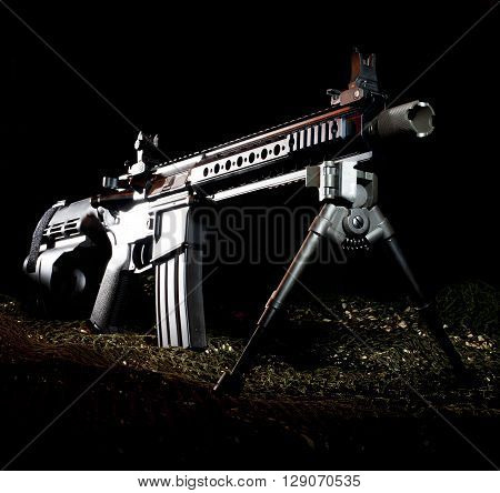 Modern sporting rifle in a pistol on a dark background