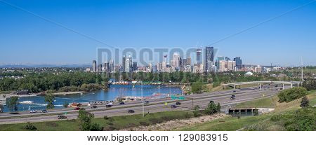 View of the Calgary skyline looking west. Deerfoot trail is in the foreground in front of the Bow River.