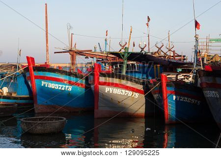 Phu Yen, Vietnam - Apr 22, 2016: Vietnamese wooden fishing boat anchoring at a harbor on a shore in Tuy Hoa beach city, central Vietnam.
