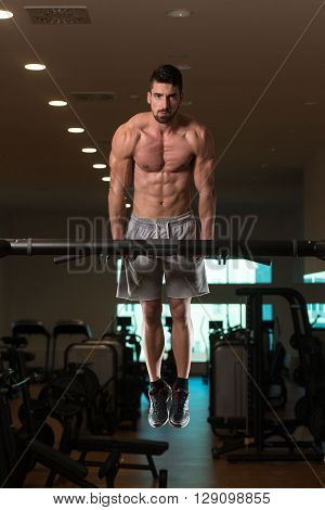 Young Bodybuilder Exercising Triceps Doing Dips On Bar