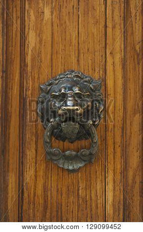Old vintage door handle. Grunge medieval background.