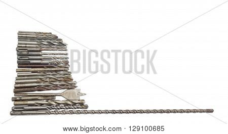 Several old drills and bits different sizes designs for different purposes and with different shapes of shank on a light background