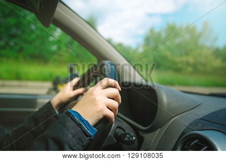 Female hands gripping car steering wheel woman driving