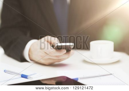 business, technology and interent concept - businessman with smartphone reading news