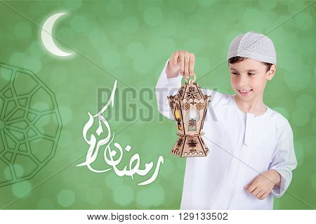 Ramadan Kareem - Translation : Muslim Holy Month Ramadan is generous - Happy young kid playing with Ramadan lantern