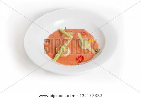 Cold gaspacho soup with scallop on white background