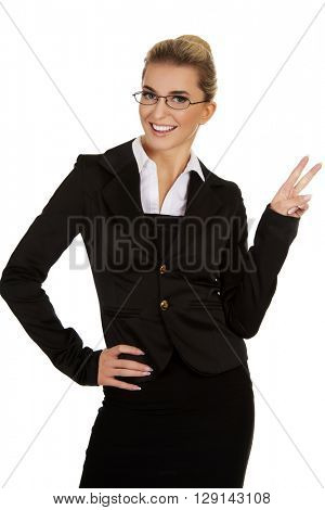 Happy businesswoman showing victory sign