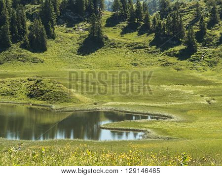 A view of the Kalbelesee lake surrounded by the Alpine mountains near village Schroecken in Bregenzerwald region Vorarlberg Austria