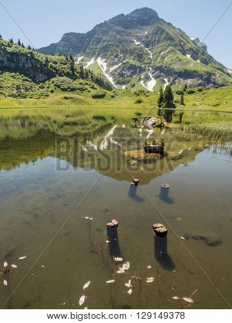 A view of Alpine mountains and the Koerbersee lake near the village Schroecken in Bregenzerwald region Vorarlberg Austria