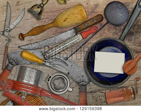 vintage utensils set for cooking over wooden table blank business card for your text