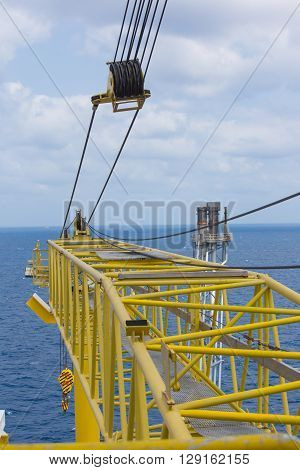 Crane boom and flare tip of oil and gas platform