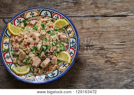Fresh quinoa and cuscus salad on decorated bowl ready for eat