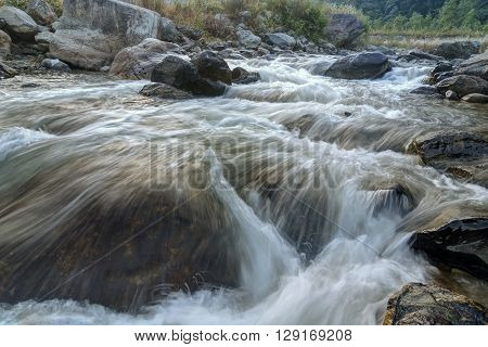 Beautiful Reshi River water flowing through stones and rocks at dawn Sikkim India. Reshi is one of the most famous rivers of Sikkim flowing through the state and serving water to many local people.