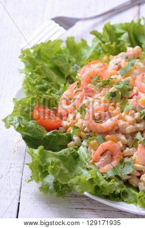 Seafood salad with shrimps on wooden backgraund