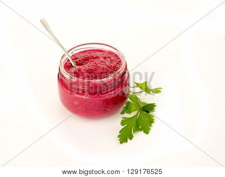Delicious Beet Horseradish in Glass Gravy Boat isolated on Wooden background