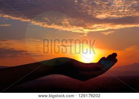 Silhouette of hand with evening sun
