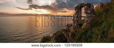 Beautiful sunset at cape Kaliakra and doorway as part of the remains of the fortress - copy space